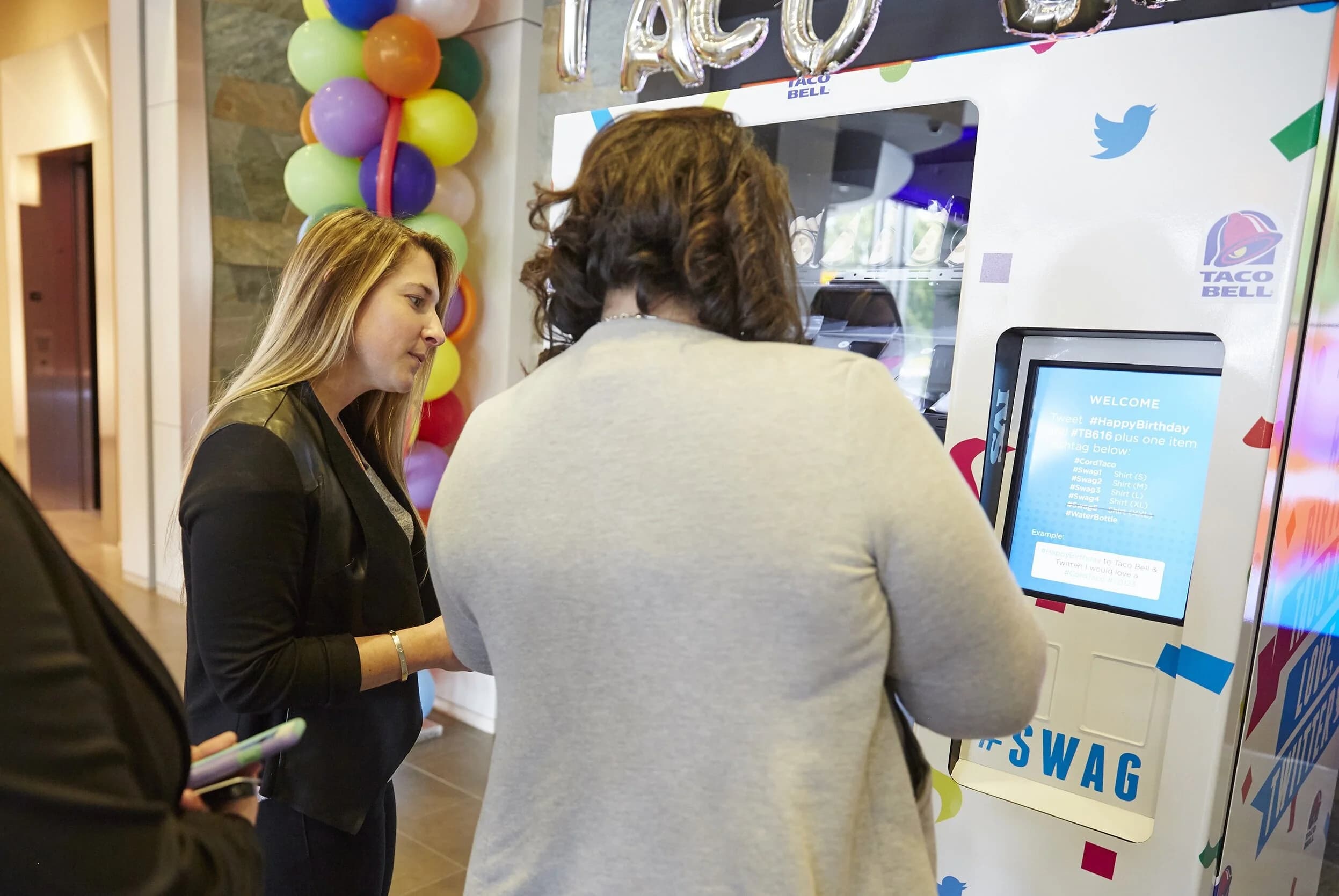 Twitter employees engaging with the vending machine activation