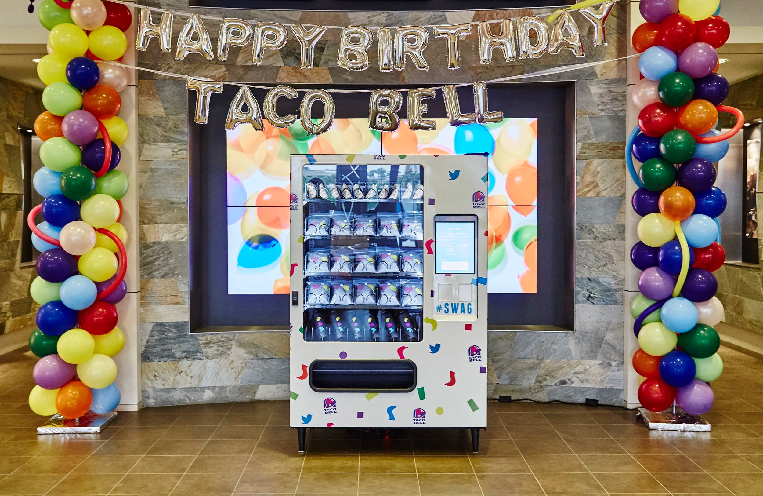 Twitter × Taco Bell vending machine — crowd at Twitter HQ activation