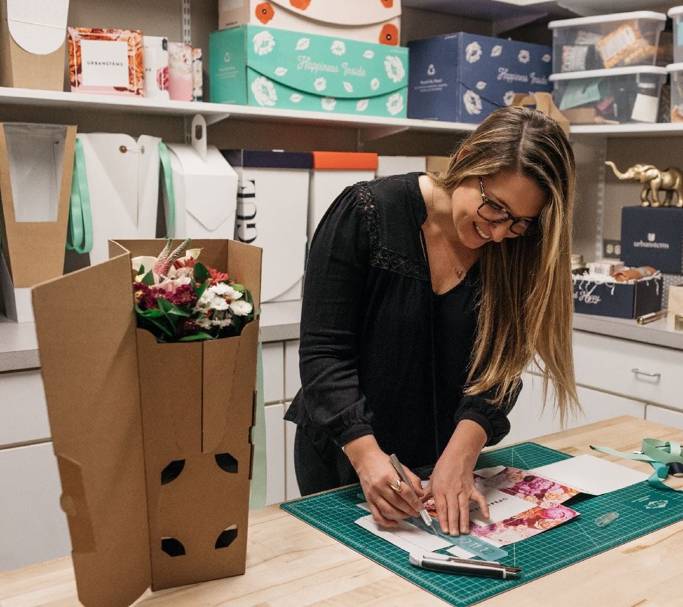Liz prototyping packaging at her worktable